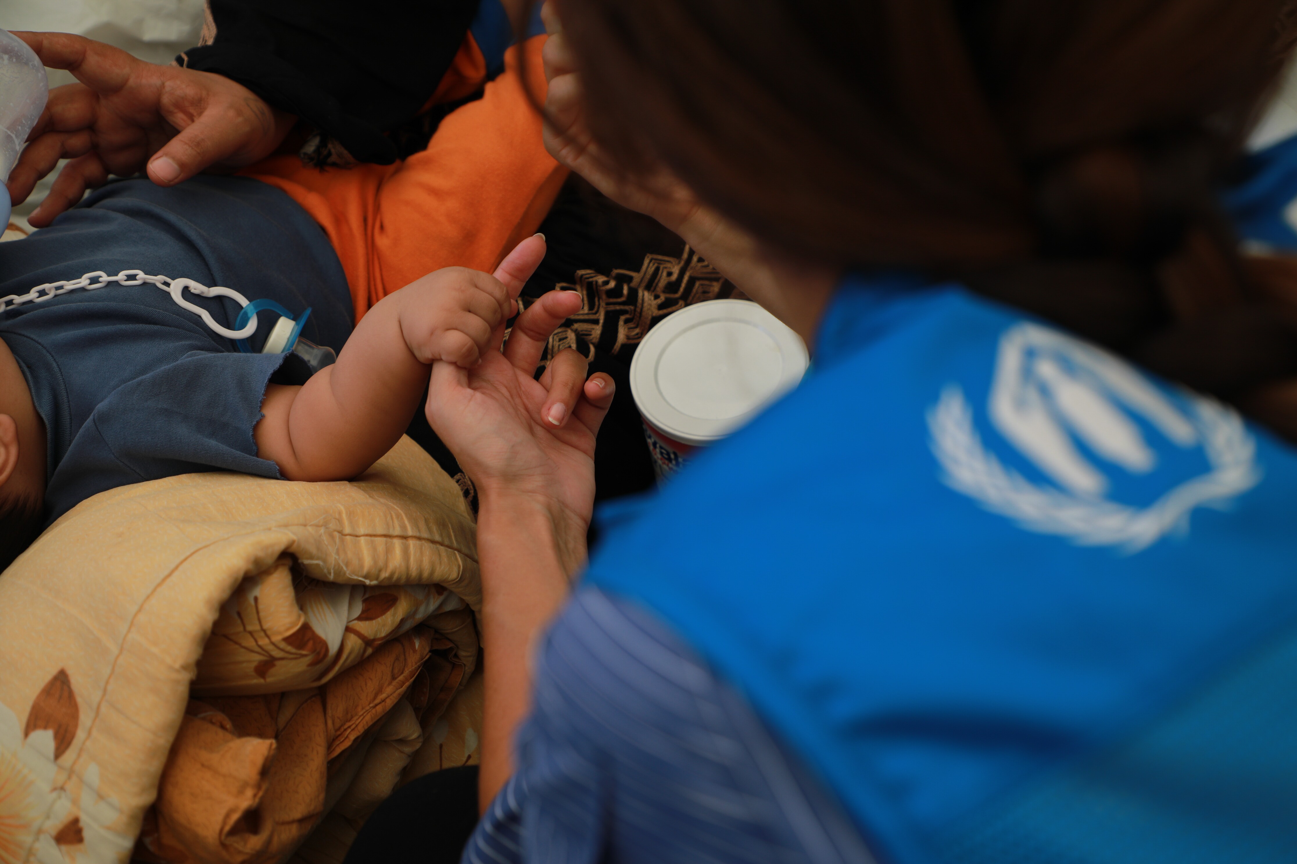 Lebanon_UNHCR-Worker-Helps-Child